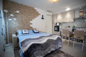 a bedroom with a large bed and a kitchen at New Apartment Venice - 8 min from San Marco Square in Venice