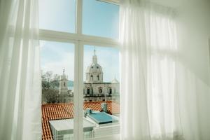 a window with a view of a building at Belém Tejo - Memória by Local in Lisbon