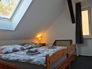 a bedroom with a large bed with a window at Ferienwohnung Prälank direkt am See in Neustrelitz