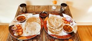 a tray of food with bread and other foods on it at Ababeel Homestay, Hartola in Rāmgarh