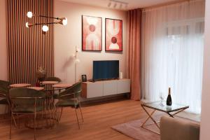 a living room with a dining table and a television at Apartament Milano in Pniewy