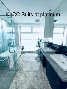 a large bathroom with two sinks and a shower at KLCC Suites at Platinum in Kuala Lumpur