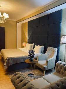 a hotel room with a bed and a couch at Sherlock Hotel Baku in Baku