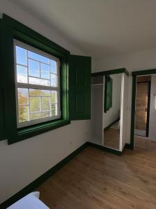 Habitación vacía con ventana y espejo en Quinta Catrinandes - Retreat Center, en Tondela