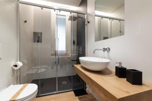 a bathroom with a sink and a glass shower at Casetta Petrera Deluxe Rooms in Bari