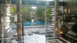 a view of a swimming pool from the inside of a house at The Riviera Monaco in Na Jomtien