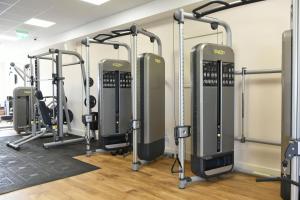 a gym with several treadmills and exercise bikes at Southview Park Hotel in Skegness