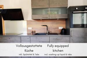 a kitchen with a sink and a microwave at Mosel-Blick: Charme & Komfort in Bremm