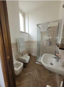 a bathroom with a toilet and a sink and a shower at Luna D'Agerola in Agerola