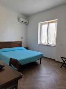 a bedroom with a bed and a window at Luna D'Agerola in Agerola