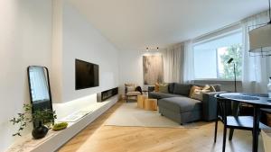 a living room with a couch and a tv at INSIDE WINTERBERG - Design Apartment - Ski Bike Sauna in Winterberg