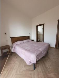 a bedroom with a bed and a mirror in it at Luna D'Agerola in Agerola