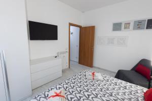 a room with a bed and a tv on a wall at Baglioni Vatican House in Rome