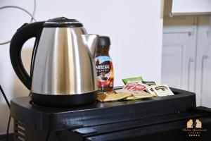 a tea kettle and a bottle of beer on a computer at BUTERA APARTMENTS LUXURY in Palermo