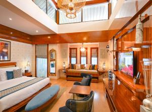 a hotel room with a bed and a desk at Palavra Resort in Manama