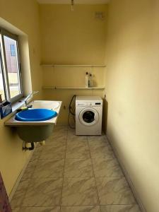 a bathroom with a washing machine and a sink at Casa Del Mare, 3Bedroom House in Marsaxlokk Fishing Village in Marsaxlokk