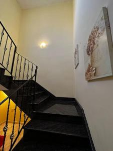 a staircase in a room with a stair case at Casa Del Mare, 3Bedroom House in Marsaxlokk Fishing Village in Marsaxlokk