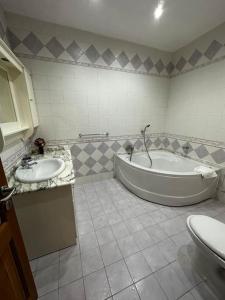 a bathroom with two sinks and a tub and a toilet at Casa Del Mare, 3Bedroom House in Marsaxlokk Fishing Village in Marsaxlokk