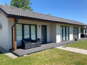 a house with two chairs on a patio at Apartmány Skleníky Spytihněv in Spytihněv