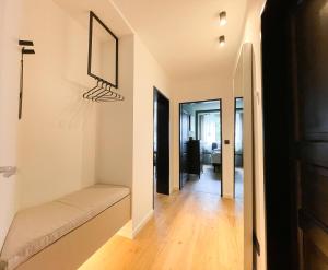 a living room with a bench and a hallway at INSIDE WINTERBERG - Design Apartment - Ski Bike Sauna in Winterberg