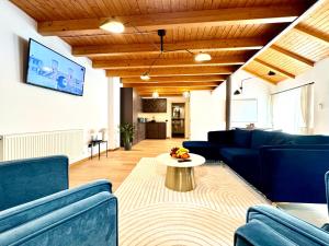 a living room with blue couches and a table at Blue Nest in Timişoara
