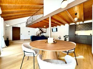 a dining room with a wooden table and chairs at Blue Nest in Timişoara
