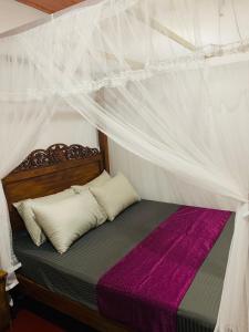 a bedroom with a bed with a canopy at No 31 in Galle