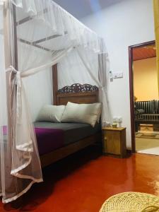 a bedroom with a bed with a canopy at No 31 in Galle