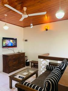 a living room with a couch and a tv at No 31 in Galle