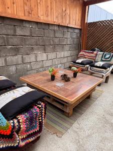 a wooden table and chairs on a patio at Casa mirador lago in Panguipulli