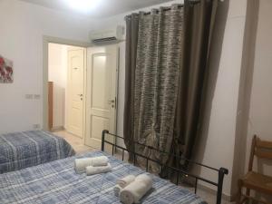 a bedroom with two beds with towels on them at Casa Petralia in Petralia Sottana