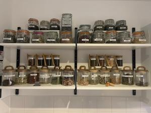 a shelf filled with lots of jars of food at Central London - The Shoreditch, Angel, Old Street Apartment in London