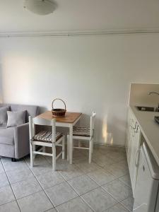 a kitchen with a table and chairs and a couch at Flat Panorama Sea View Studio for Couples Vrachos in Preveza