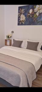 Casa 7 Sate في ساتشيلي: سرير كبير في غرفة نوم مع لوحة على الحائط
