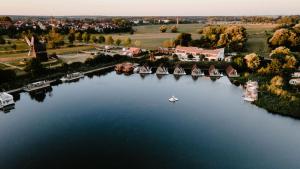 an aerial view of a lake with a boat in it at Strandhaus Hotel in Parey