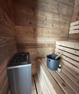 a sauna with a stove and a bucket in it at YAK Hauesl in Fleres