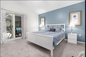 - une chambre avec un grand lit aux murs bleus dans l'établissement Tropical Escape by Shine Villas 244 villa, à Kissimmee