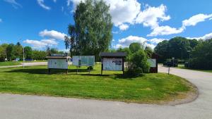 Smålands gemütliche Apartments direkt am Fluss في Högsby: بضع علامات في العشب بجوار الطريق