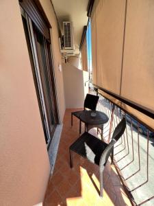 a balcony with a table and chairs on a building at Anfitrite B&B Tropea in Tropea +18 photos