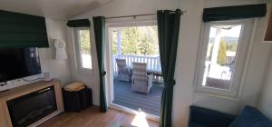 a living room with a sliding glass door to a deck at Haus Ballum in Birgland