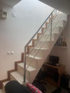 a staircase in a room with a desk and a computer at Sunny Luanda in Luanda