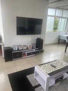 uma sala de estar com uma grande televisão de ecrã plano em Sunny Luanda em Luanda