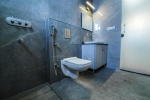 a bathroom with a toilet and a shower at RC Comforts in Chikmagalūr