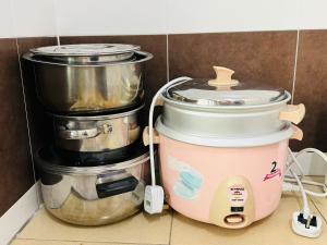a kitchen with two pots and a slow cooker at Hasnifana Homestay Seri Iskandar in Seri Iskandar