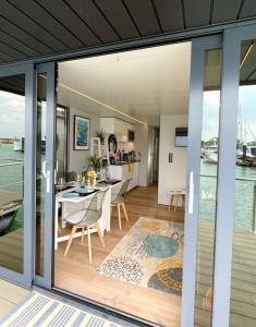 a kitchen and dining room with a view of the water at Yarmouth Waterlodge Floating Apartment 1 in Yarmouth