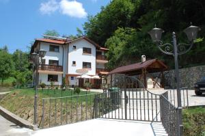 a building with a playground in front of a house at Guest House Savina in Plachkovtsi