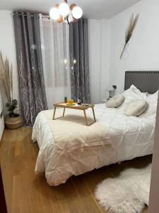 a bedroom with a bed with a table on it at Apartamento Miranda in Villaviciosa