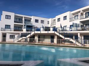 an apartment building with a swimming pool in front of it at Casa Elias - Costa Calma Sun & Beach in Costa Calma