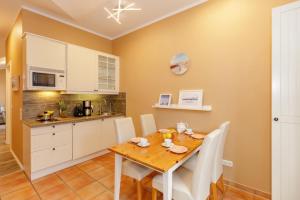 a kitchen and dining room with a wooden table and chairs at Stolz-Butze Whg 19 in Kühlungsborn