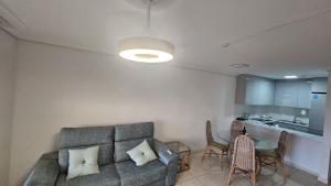 a living room with a couch and a table at Residencial Chayofa, 1 dormitorio in Chayofa